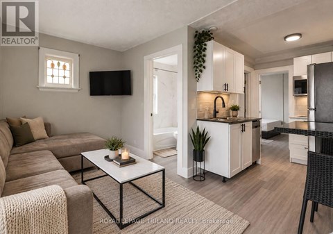 A modern living room with a brown sofa and a white coffee table.