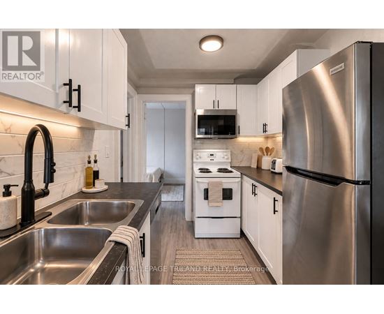 A modern kitchen with stainless steel appliances and white cabinets.