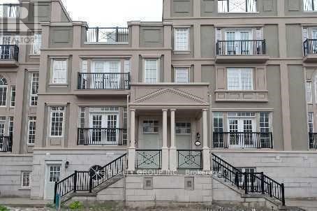 A building with a balcony and a staircase leading to the entrance.