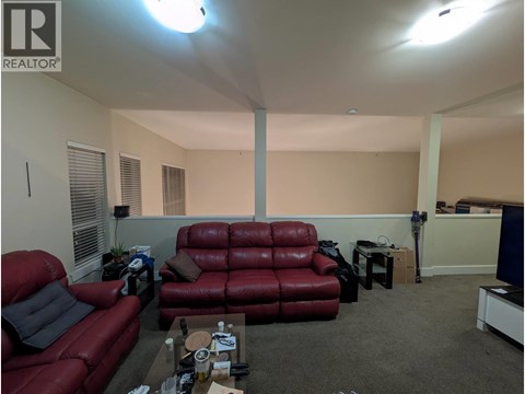 A living room with a red couch and a coffee table.