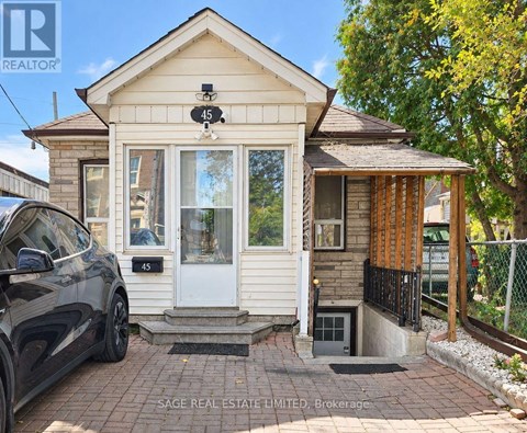 A small house with a car parked in front of it.