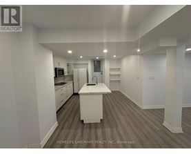 A spacious kitchen with white cabinets and a central island.