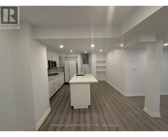 A spacious kitchen with white cabinets and a central island.