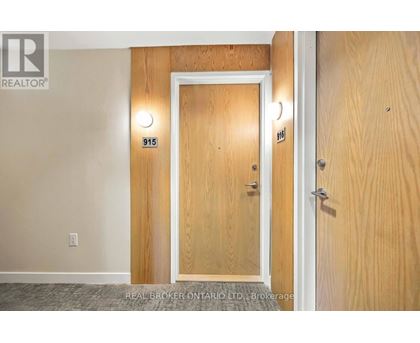 A wooden door with the number 915 on it.