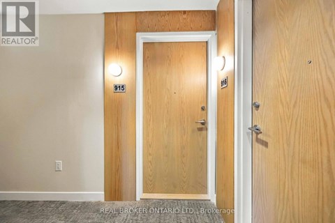 A wooden door with the number 915 on it.