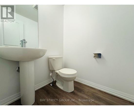 A white toilet sits next to a sink in a bathroom.