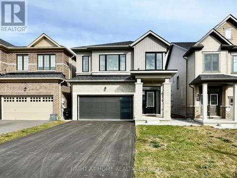 A large, modern house with a garage is for sale.