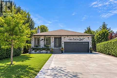 A house with a garage and a driveway in front.