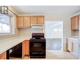 A kitchen with wooden cabinets and a black stove top oven.