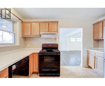 A kitchen with wooden cabinets and a black stove top oven.