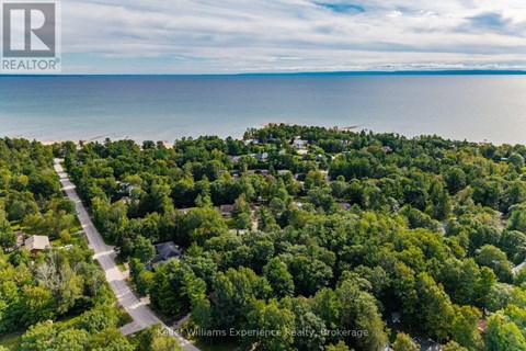 A bird's eye view of a residential area with a road running through it.