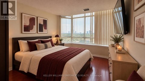 A bedroom with a large bed and a flat screen TV mounted on the wall.