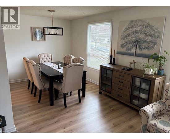 A dining room with a table and chairs.