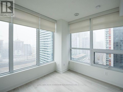 A white room with a large window overlooking a cityscape.