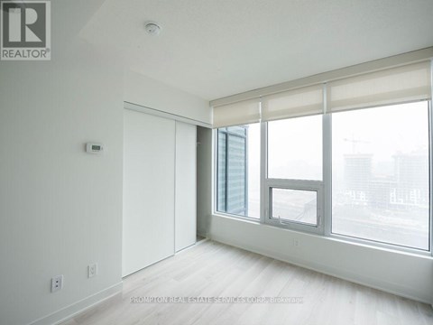 A white room with a window and a door.