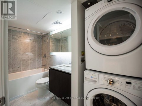 A washer and dryer stacked on top of each other in a laundry room.