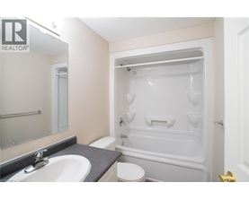 A bathroom with a sink, toilet, and bathtub.