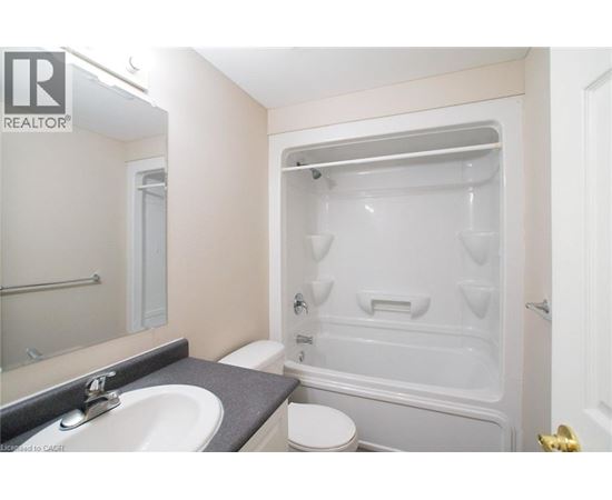 A bathroom with a sink, toilet, and bathtub.