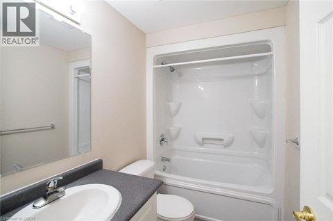 A bathroom with a sink, toilet, and bathtub.