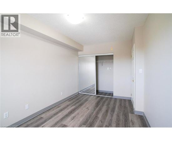 A room with a wooden floor and white walls.
