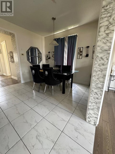 A dining room with a table and chairs.