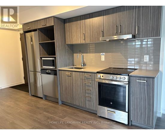 A modern kitchen with wooden cabinets and stainless steel appliances.