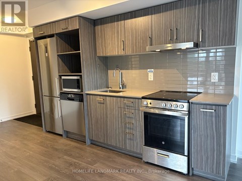 A modern kitchen with wooden cabinets and stainless steel appliances.