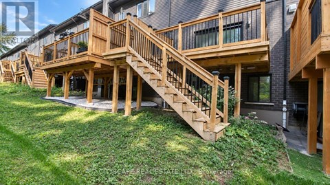 A wooden deck with stairs leading to a building.