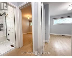 A bathroom with a walk-in shower and a wooden floor.