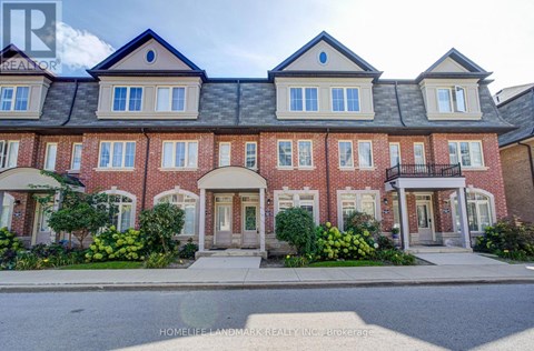 A row of townhouses with a sign that says "HOMELIFE LANDMARK REALTY INC Brokerage".