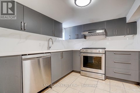 A kitchen with a stainless steel dishwasher and oven.
