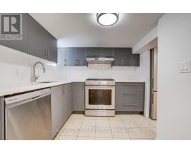 A kitchen with a stainless steel dishwasher and an oven.