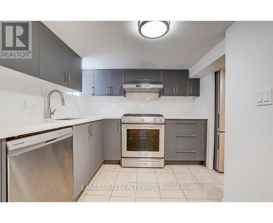 A kitchen with a stainless steel dishwasher and an oven.