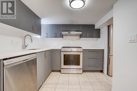 A kitchen with a stainless steel dishwasher and an oven.
