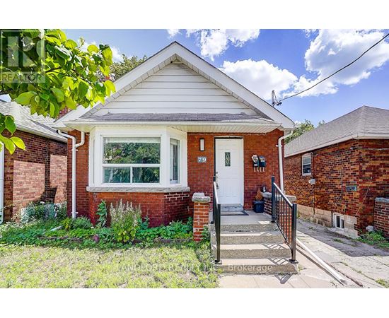 A small red brick house with a white door and a small front porch.