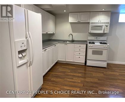 A kitchen with white appliances and cabinets.