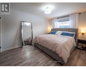 A bedroom with a large bed and a mirror on the wall.