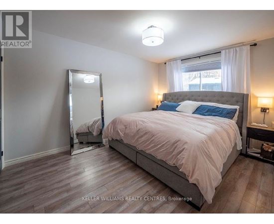 A bedroom with a large bed and a mirror on the wall.