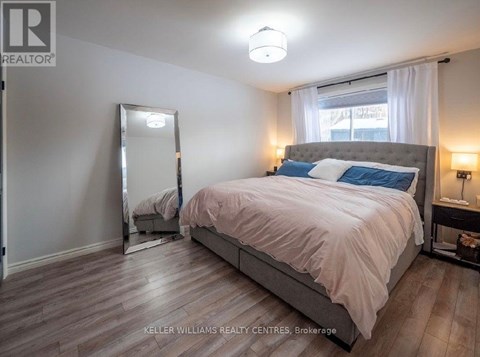 A bedroom with a large bed and a mirror on the wall.