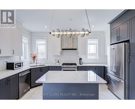 A modern kitchen with a marble island and stainless steel appliances.