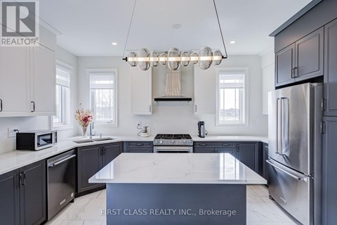 A modern kitchen with a marble island and stainless steel appliances.