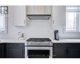 A modern kitchen with a stove top oven and a coffee maker.