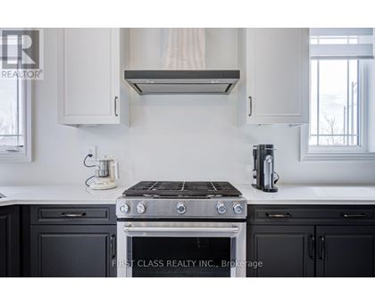 A modern kitchen with a stove top oven and a coffee maker.