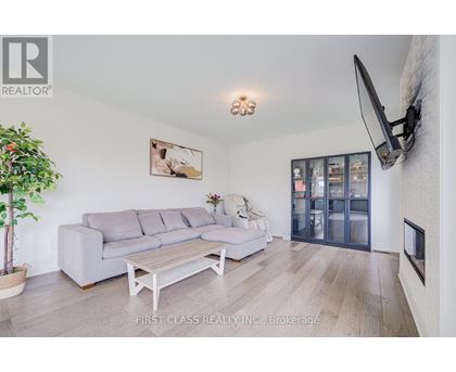 A living room with a grey couch and a wooden coffee table.