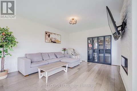 A living room with a grey couch and a wooden coffee table.