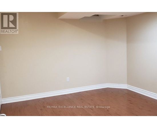 A room with a wooden floor and beige walls.