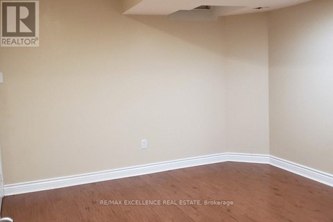 A room with a wooden floor and beige walls.