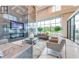 A modern living room with a large television and comfortable seating.
