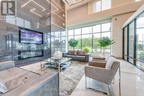 A modern living room with a large television and comfortable seating.