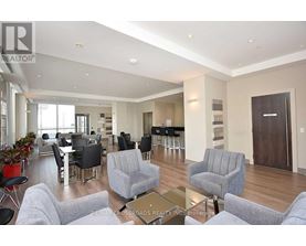 A living room with grey couches and a glass coffee table.